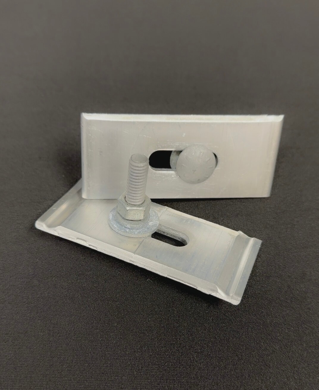Two large clip assemblies for bleachers produced by Southeastern Seating.