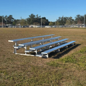 Southeastern Seating tip 'n roll bleachers on a field.