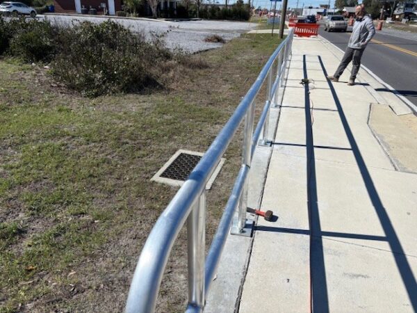 Looking down the top railing of a two-row aluminum pipe with baseplate mounting or core drilled mounting.